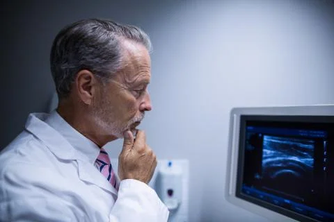 Surgeon looking at ultrasonic device machine Stock Photos