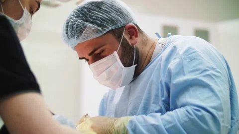 Surgeon man performs surgery in a mask Stock Footage 160938930