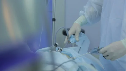 Surgeon in modern operating room operates on patient, minimally invasive method Video stock 128643101