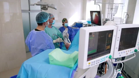 Surgeon moves laparoscopic devices input into patient's leg.  Stock Footage 252698324