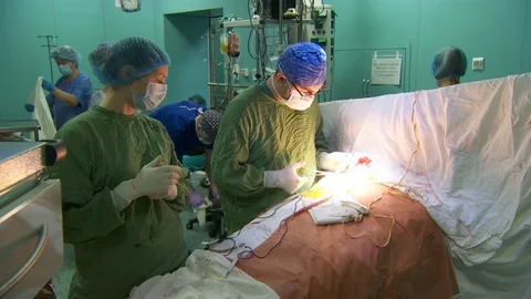 Surgeon near the operating table. surgeons perform heart surgery. during Video stock 95941053