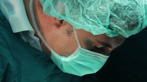 Surgeon operate close up face tilt down cutting incision Stock Footage 34929720