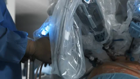 Surgeon operates patient using modern, advanced medical robot in operating room Stock Footage 242165592