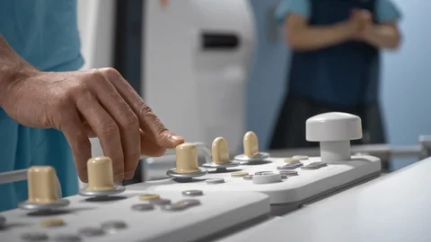 Surgeon operates robotic diagnostic system via remote control panel, close-up Stock Footage 119653283