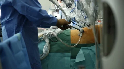 Surgeon operating with a medical robot Stock Footage 85901430