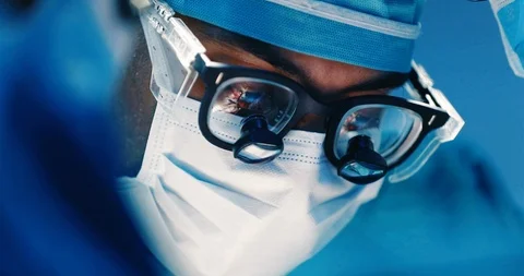 Surgeon operating with operation in eye glasses reflection Stock Footage 126616029