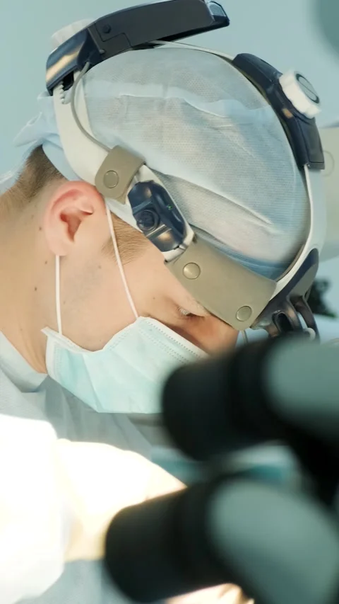 Surgeon operating with precision using magnification Stock Footage 315752381