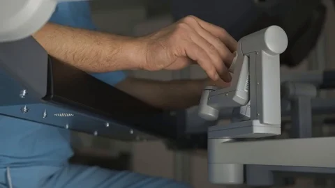 Surgeon operating robotic surgery machine, Minimally Invasive Da Vinci System Stock Footage 89583141