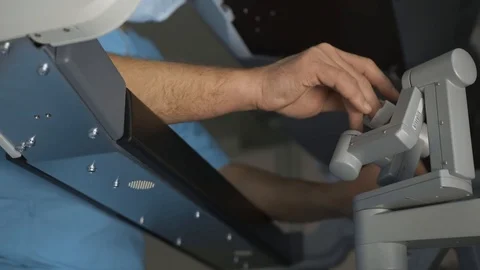 Surgeon operating robotic surgery machine, Minimally Invasive Da Vinci System Stock Footage 89583267