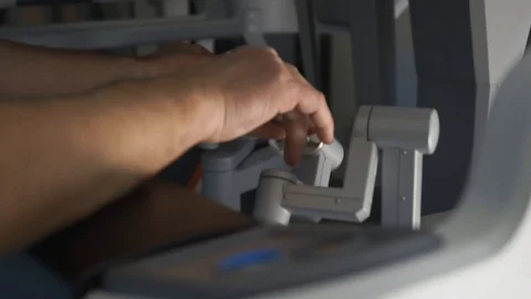 Surgeon operating robotic surgery machine, Minimally Invasive Da Vinci System Stock Footage 89583609
