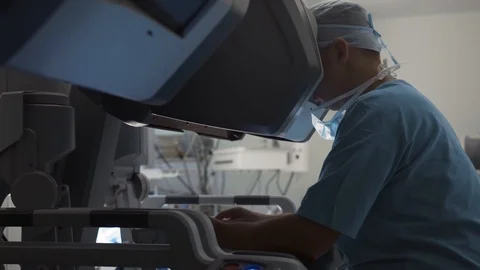 Surgeon operating robotic surgery machine, Minimally Invasive Da Vinci System Stock Footage 89583772