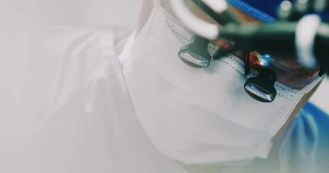 Surgeon operating with surgery in reflection of his glasses Stock Footage 126477712