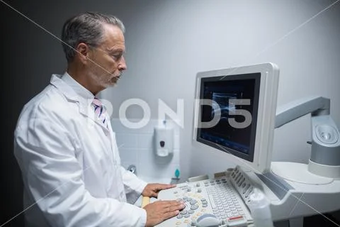 Surgeon operating ultrasonic device machine Stock Photos