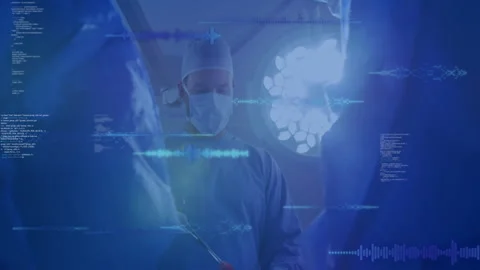 Surgeon operating under OR lamp with interface fading code and DNA visuals 스톡 동영상 312904771