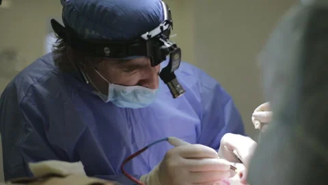 Surgeon  perform an operation on a patient. Doctors Fight for Patient's Life Stock Footage 129548084