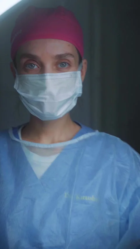 Surgeon performing a complex procedure in a modern operating room at a hospital Stock Footage 295864340