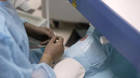Surgeon performing delicate eye surgery Stock Footage 334083501