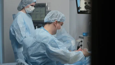 Surgeon Performing Eye Surgery under Operating Microscope Stock Footage 310252030