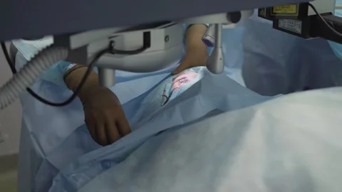 Surgeon performing laser vision correction surgery in clinic Stock Footage 328052364