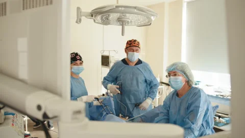 Surgeon performing operation. The surgeon's holing the instrument in abdomen of Stock Footage 172404159
