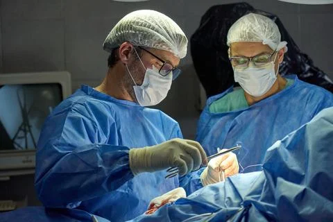 Surgeon Performing a Procedure in a Modern Operating Room Stock Photos