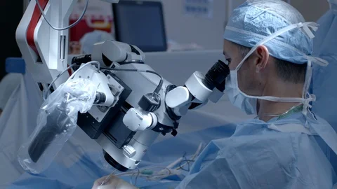 Surgeon Performing Surgery with a Microscope Stock Footage 127195983