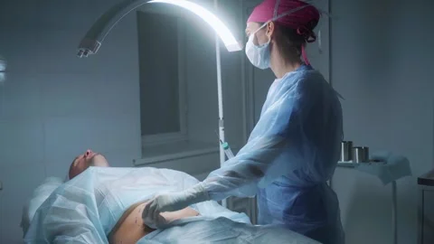 Surgeon performs a critical procedure involving a stomach incision in an Video stock 295864563