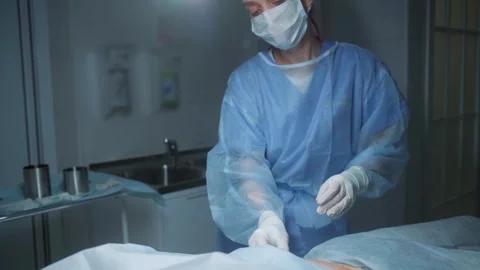 Surgeon performs a delicate operation in a sterile environment at a medical Stock Footage 295864432