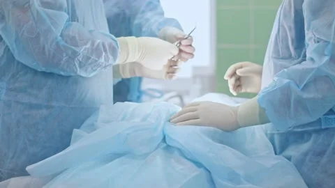 The surgeon performs a surgical operation Stock Footage 150884978