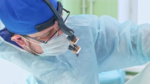 The surgeon performs a surgical operation Stock Footage 150885299
