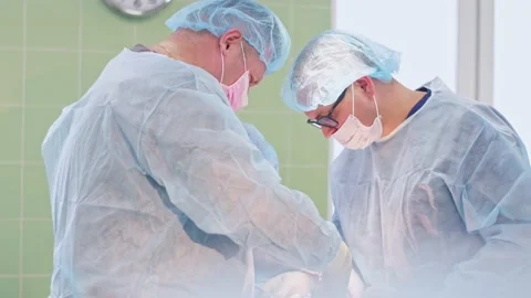 The surgeon performs a surgical operation Stock Footage 150885450