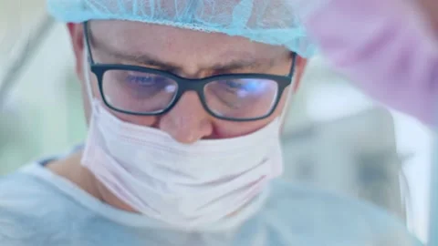 The surgeon performs a surgical operation Stock Footage 150886913
