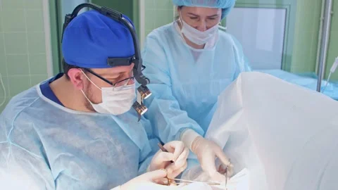 The surgeon performs a surgical operation Stock Footage 150888832