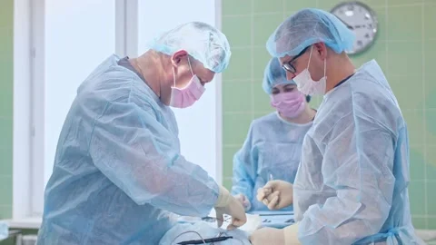 The surgeon performs a surgical operation Stock Footage 150889582