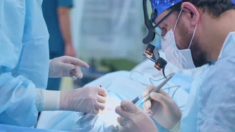 The surgeon performs a surgical operation Stock Footage 150890616