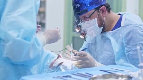 The surgeon performs a surgical operation Stock Footage 150890810
