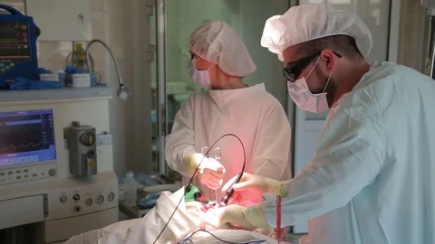 The surgeon performs a surgical procedure. Photodynamic therapy. a cure for Stock Footage 79265127