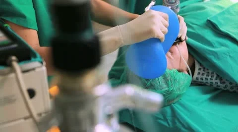 Surgeon placing a resuscitation bag on a patient Stock Footage