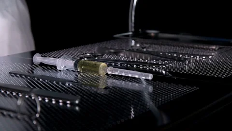 The surgeon prepares the syringe on the table with the tools for the operation Stock Footage 81007597
