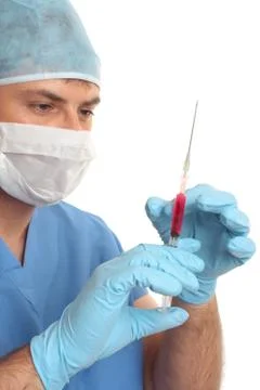 Surgeon preparing checking needle syringe Stock Photos