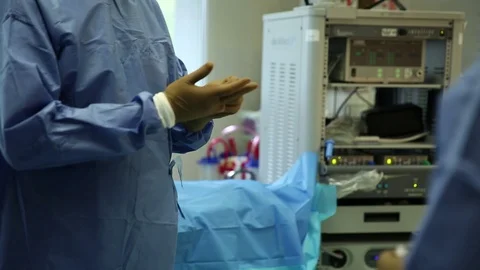 Surgeon preparing his gloves for operation Stock Footage 85896213