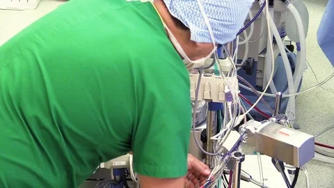 Surgeon preparing a medical machine Stock Footage 85898583