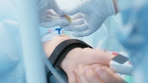 Surgeon Preparing Patient’s Arm with IV Catheter in an Operating Room for Neuros 動画素材 296931022