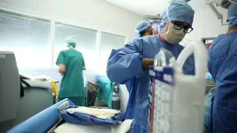 Surgeon preparing products for operation Stock Footage 85894093