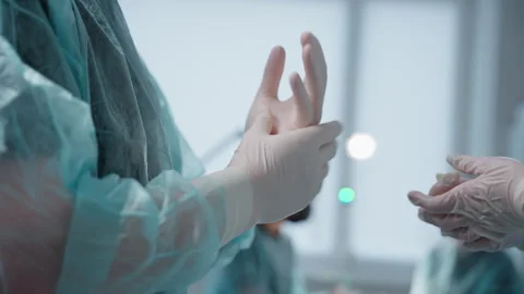 Surgeon Preparing for Surgery. Adjusting Gloves and Rubbing Hands. Close-Up Stock Footage 302548169