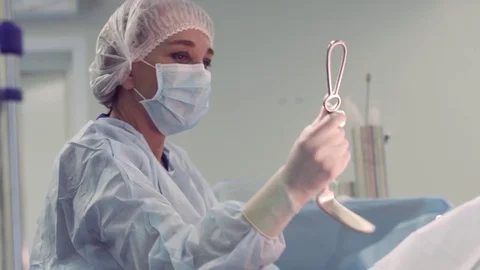 Surgeon, Professor, intently doing her job. Surgeon and surgical team are Stock Footage 81490567