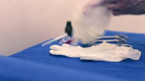 Surgeon puts on gloves Stock Footage 74340447