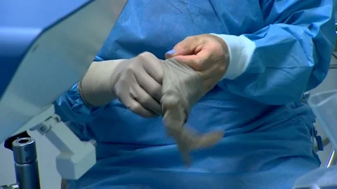 The surgeon putting on gloves before surgery Stock Footage 83143741