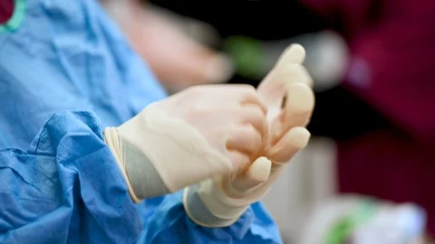 Surgeon putting protective Gloves on Before Operation. Close up view. Stock Footage 125108150