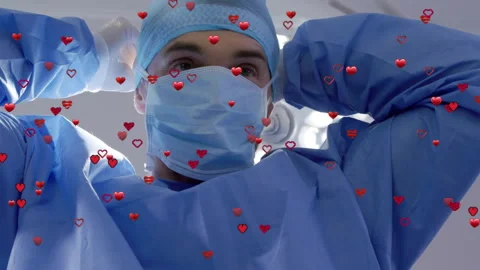 Surgeon reaching up adjusting bouffant cap under light as floating hearts Stock Footage 314687199